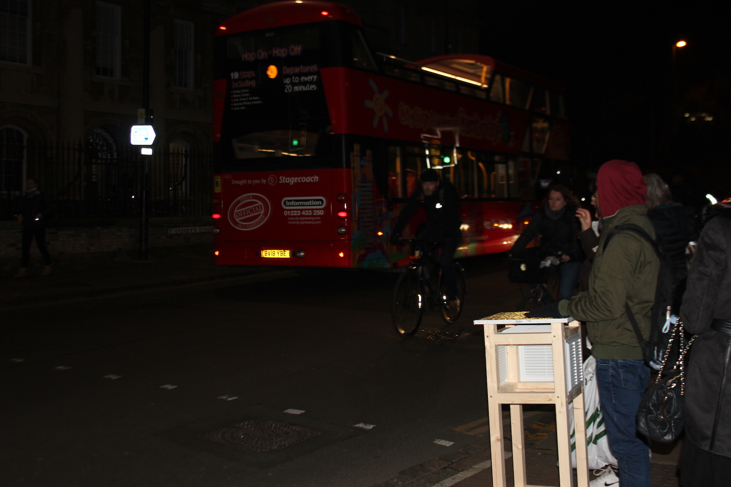 Researcher waiting at a pedestrian crossing to take a Stevenson screen across the road